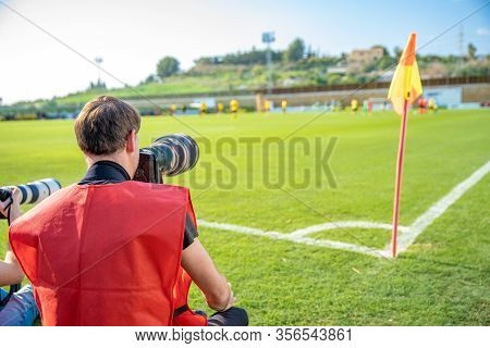 Photoreporter With Telephoto Lens On A Football Match