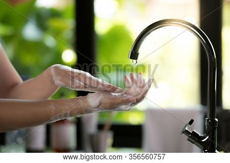 Hands Being Washed Scrubbed And Rinsed Using Disinfectant Soap For Hygiene And Protection Against Co
