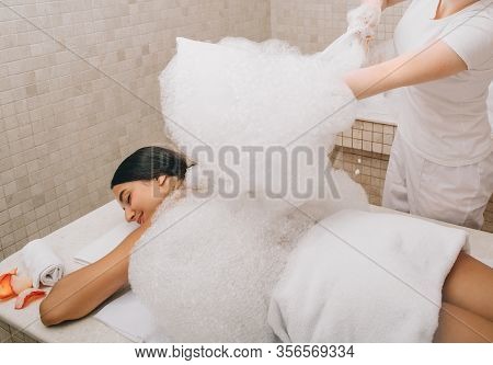 Hammam Worker Doing Foam Massage On A Marble Hot Table Of Turkish Bath. Hammam Improving Skin And St