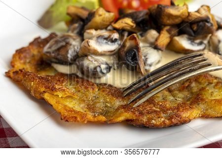 Swiss Roesti With Mushroom Sauce And A Fork