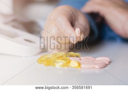 Elderly woman with pills hand, grandmother with medicines