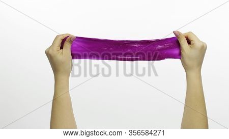 Woman Hands Playing With Oddly Satisfying Purple Slime On White Background. Sticky Gooey Substance. 