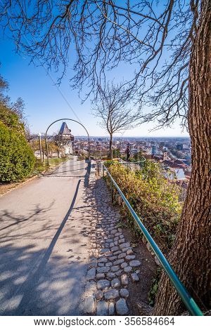 On The Hill Schlossberg With Tower Uhrturm In Deserted Town Graz, Styria At Virus Quarantine In Spri