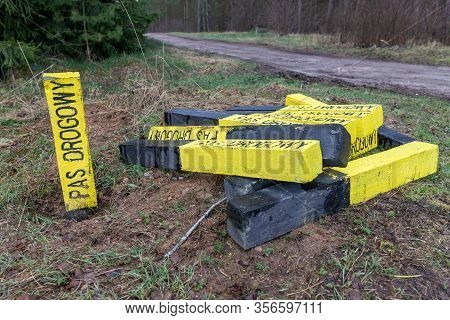 A Yellow Road Post Standing By The Road. Marking Of The Road Lane On The Side Of The Road.