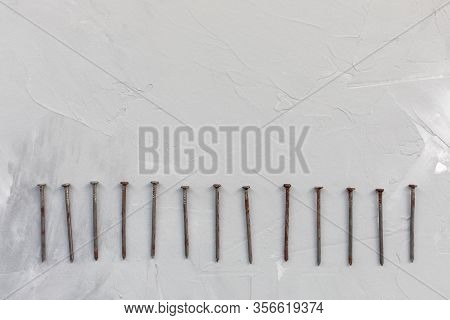 Old Rusty Nails On Gray Background, Carpentry Concept, Copy Space