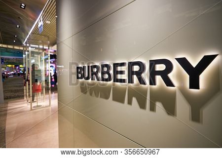 SINGAPORE - APRIL 21, 2019: close up shot of Burberry sign seen in Singapore Changi Airport. Burberry Group PLC is a British luxury fashion house headquartered in London, England.