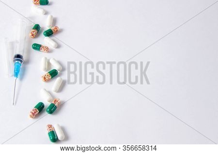 Coronavirus Phrase Text On A White Background With Medicines And Pills. The Concept Of The New 2019 