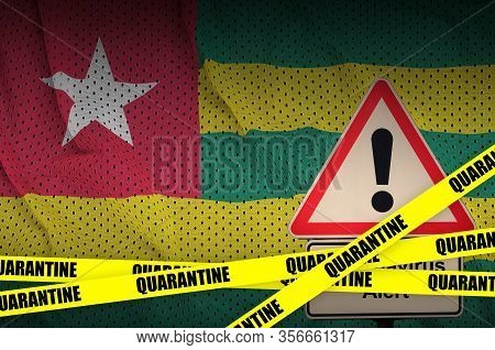 Togo Flag And Covid-19 Quarantine Yellow Tape. Coronavirus Or 2019-ncov Virus