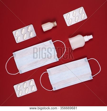 P Revention Of C Oronavirus. Medical Masks, Vitamins, Antiseptic On A Red Background.