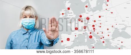 Adult Woman In Medical Mask Shows A Stop Sign Amid Foci Of Infection Europe Map. Protection Against 