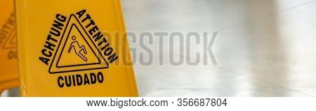 Panoramic Shot Of Wet Floor Sign On Clean Slippery Floor In Office