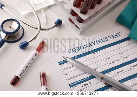 Laboratory Bench With Blood Samples For Coronavirus Analysis And Patient Test Sheet. Top View.
