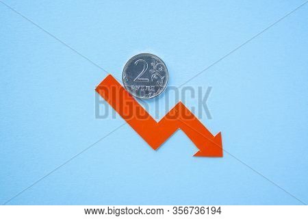 Two Rouble Coin On Blue Background With Red Arrow Down. Exchange Rate Chart. Ruble Depreciation. Exc