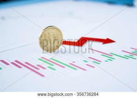 Ten Rouble Coin On Currency Graph With Red Arrow Down. Exchange Rate Chart. Ruble Depreciation. Exch