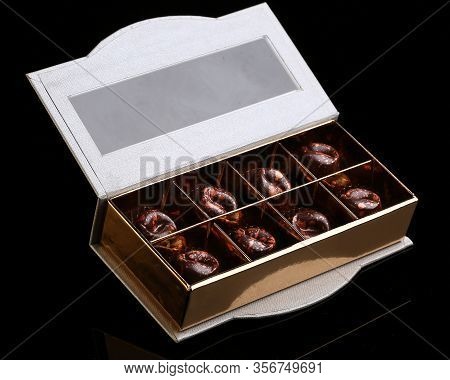 Painted Luxury Handmade Bonbons In A Gift Box On A Black Background. Chocolates For Valentine's Day.