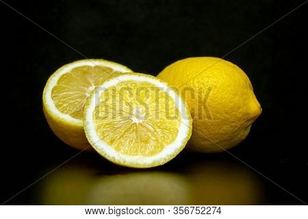 Fresh Juicy Yellow Snooty Lemon On A Black Background