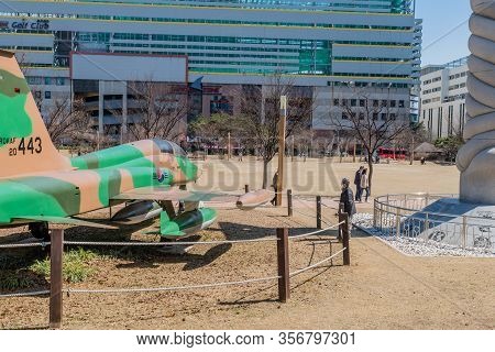 Daejeon, South Korea; March 16, 2020: Man Wearing Face Mask Looking At Northrop F5 Freedom Fighter O