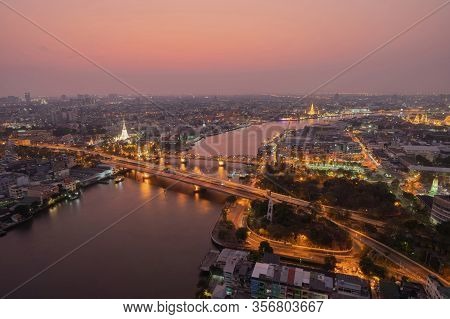 Aerial View Of White Prayoon Pagoda, Memorial Bridge, And Phra Pok Klao Bridge With Buildings And Cu