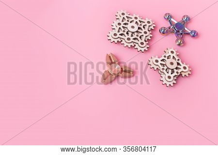 Fidget Finger Spinners Antistress, Anxiety Relief Toy On Pink Background. Spinners Made Different Ma