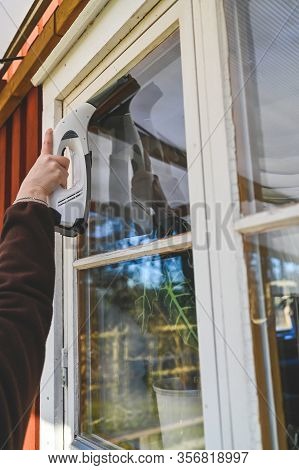 Cleaning Windows On A Cabin With A Machine