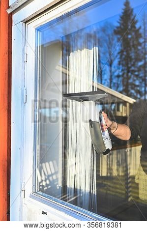 Cleaning Windows On A Cabin With A Machine
