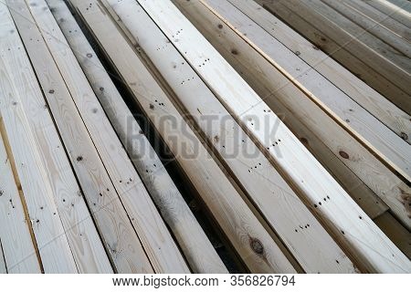 Pile Of Pine Wood In A Warehouse Or Storage Room. Wood Proceesing, Wood For Furniture