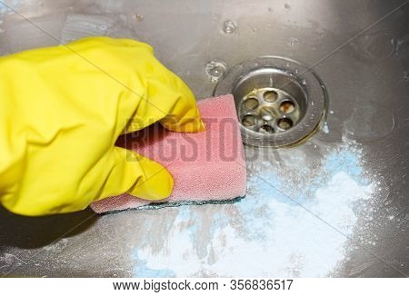 Hands In Protective Gloves Clean The Sink With Cleaning And Disinfecting Powder.