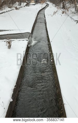 Urban Streams In Winter. The Lybid River (kyiv, Ukraine) In The Snow.