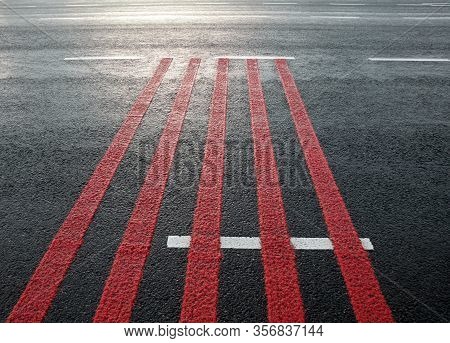 Red Rumble Strips On The Road. Sleeper Lines, Alert Strips, Audible Lines, Sleepy Bumps. Wake Up Cal