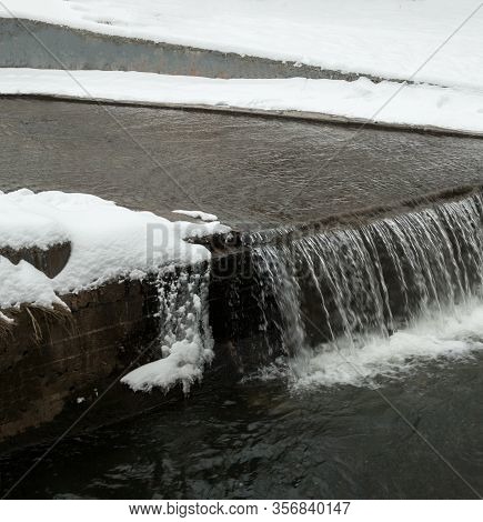 Urban Streams In Winter. The Lybid River (kyiv, Ukraine) In The Snow.