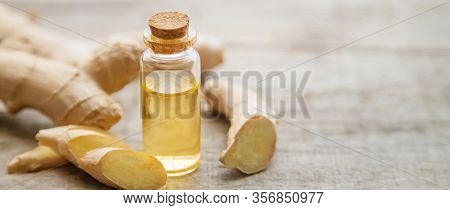 Ginger Essential Oil In A Small Bottle. Selective Focus.