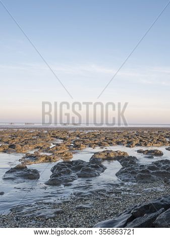 Aerial View Of Horizon Over Sea, With Mounds Of Mud In The Foreground, National Park And Unesco Worl