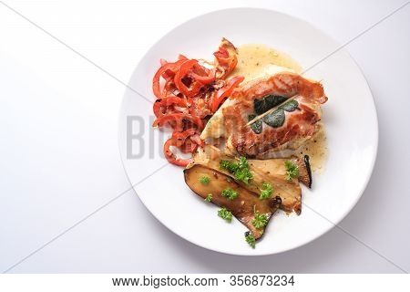Roasted Chicken Saltimbocca With Air-dried Ham And Sage Leaves On A Plate With Red Bell Peppers And 