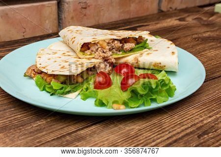 Fajitos With Minced Meat Vegetables In A Corn Tortilla On A Blue Plate Dark Wooden Background. Fast