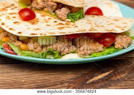 Fajitos With Minced Meat Vegetables In A Corn Tortilla On A Blue Plate Dark Wooden Background. Fast 