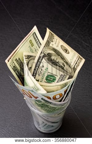 Hundred Dollar Bills Are Twisted Into A Tube And Placed In A Glass. Decoration Of Money. Selective F