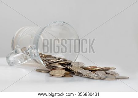 Trifle Russian Coins Pouring From A Glass Jar On A White Background, Concept Of Low-denomination Coi