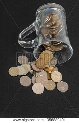 Trifle Russian Coins Pouring From A Glass Jar On A Black Background, Concept Of Low-denomination Coi