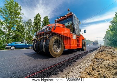 Tandem Vibration Roller Compactor Working On Asphalt Pavement, Selective Focus On Road Repair.