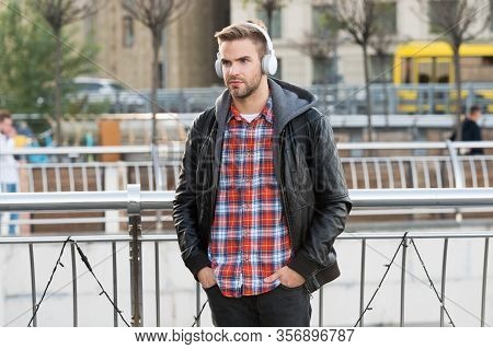 Deliver Perfect Audio Reproduction. Young Man Wear Audio Headphones Outdoor. Handsome Guy Listen To 