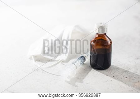 Medical Surgical Mask, Syringe And Bittles On White Background