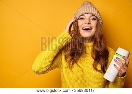 Beautiful Brunette See Clean Skin In A Yellow Sweater And Hat Stands On A Yellow Background Laughing