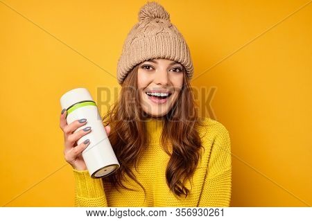 Beautiful Brunette See Clean Skin In A Yellow Sweater And Hat Stands On A Yellow Background Joyfully