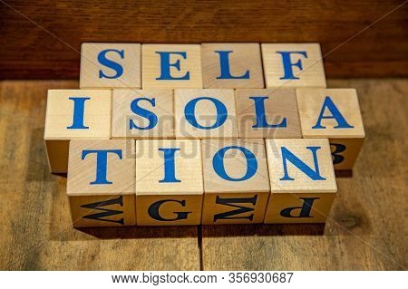 Self-isolation. Wooden Cubes With Blue Letters