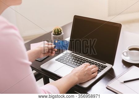 Shopping Online During Quarantine. Senior Lady Purchasing In Internet With Credit Card And Laptop At