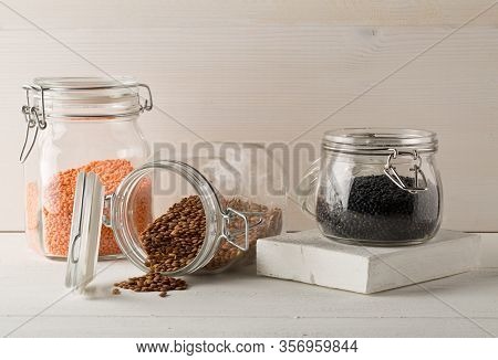 Different Assorted Lentils Mix With Red, Brown And Black Beluga Lentils In Glass Storage Jars On Whi