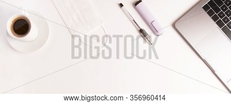 Flat Lay Composition With Medical Mask, Laptop, Coffee, Pen On White Background. Banner. Copyspace. 