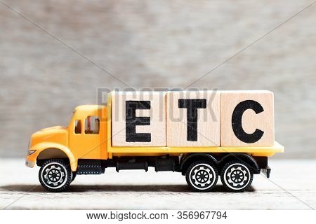 Truck Hold Letter Block In Word Etc (abbreviation Of Et Cetera) On Wood Background
