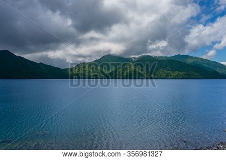 Mountain Lake Landscape With Green Forest On Mountain Slopes. Lake Chuzenji In Chugushi, Japan