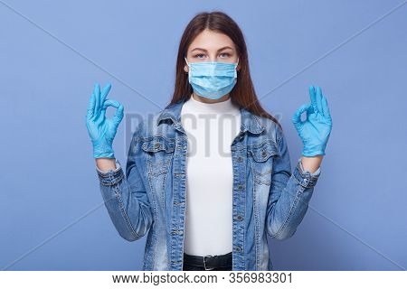 Picture Of Young Woman Showing Sign Ok, Invoking To Not Panic, Lady Wearing Protective Face Mask And